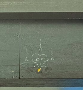 Traditional Buddhist blessing symbol drawn on a wooden beam inside The Baht Thai Restaurant during a ceremonial blessing in Gatlinburg, Tennessee.